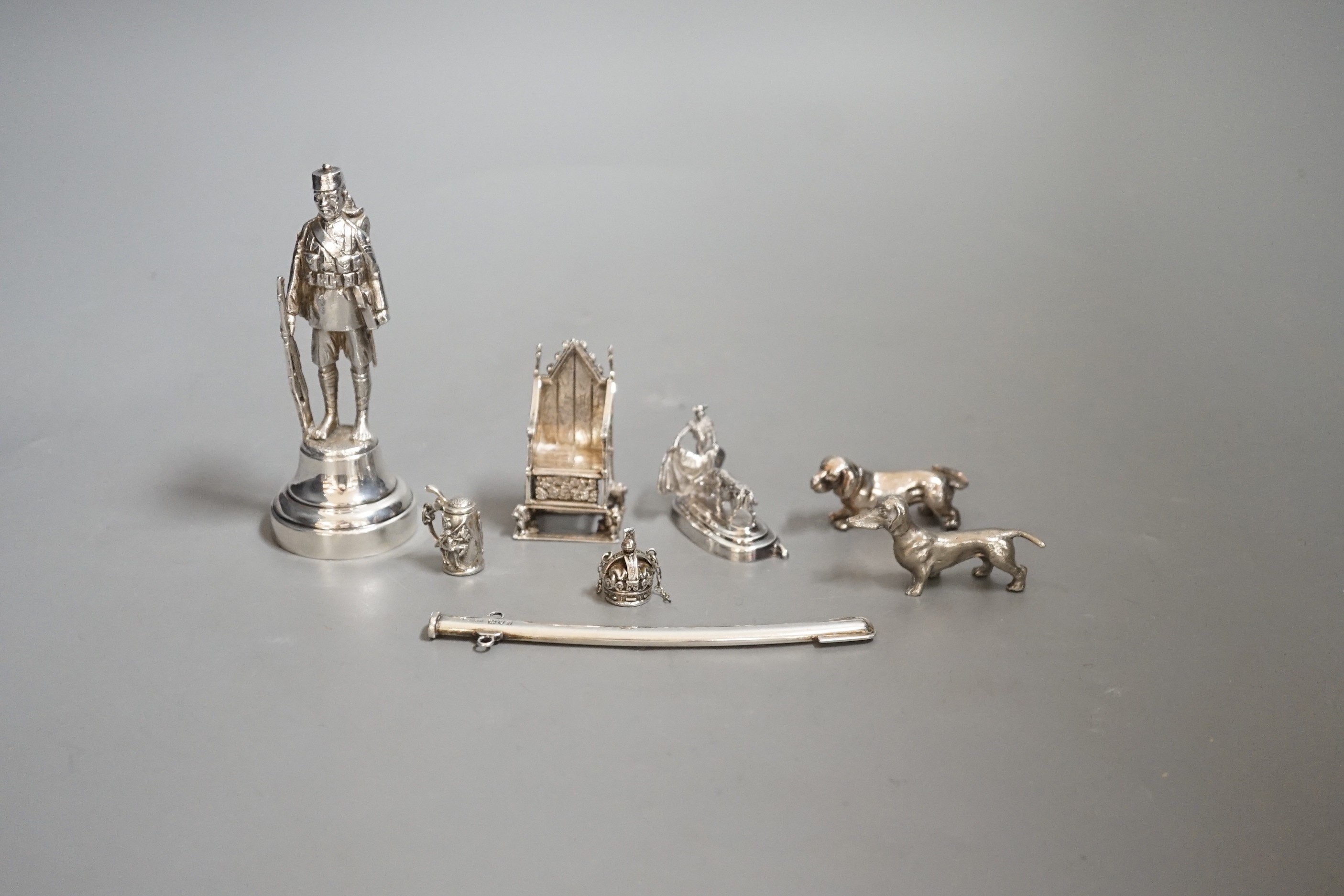 A group of novelty miniature silver items to include a sword, a solider by Goldsmiths & Silversmiths Co Ltd, London, 1930, 10.5cm, a throne, a matador figure, etc.